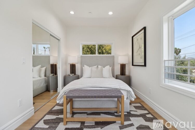 A bedroom with a large bed and a window overlooking the outdoors.