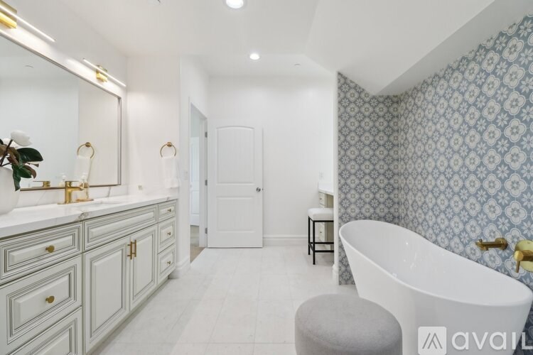 A bathroom with a white tub and a white door.