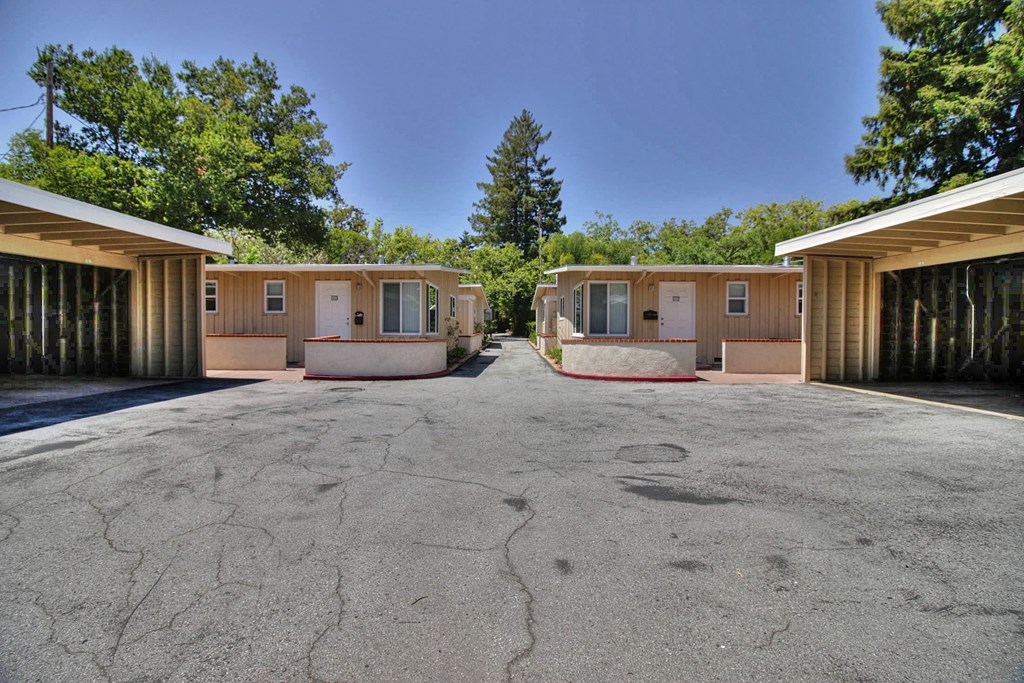 Two buildings in the background of a paved area