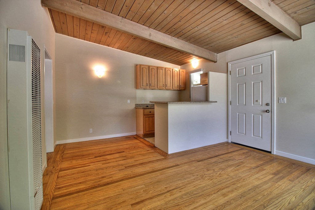 A room with wooden floors and a white door.