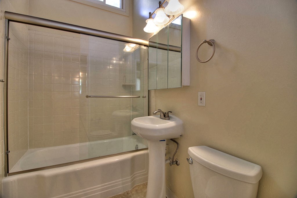 A white sink is on the counter of a bathroom.