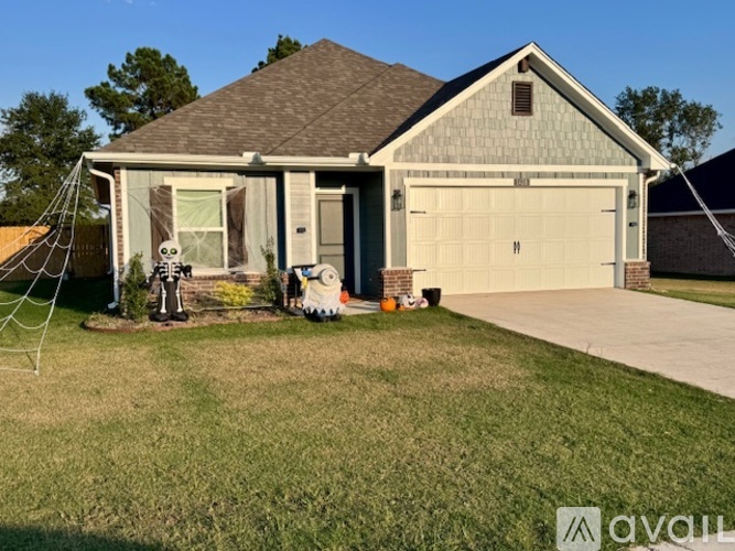 A house with a garage and a driveway in front.