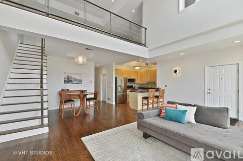 A living room with a grey couch and a wooden table.
