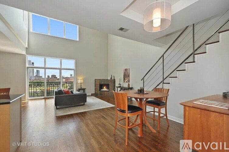 A living room with a fireplace and a dining table.