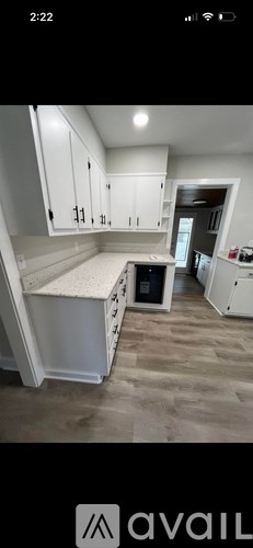 A kitchen with white cabinets and a countertop.