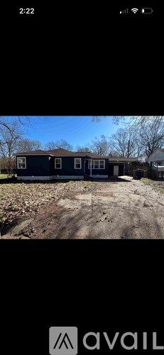 A house with a brown roof and a blue door is shown.