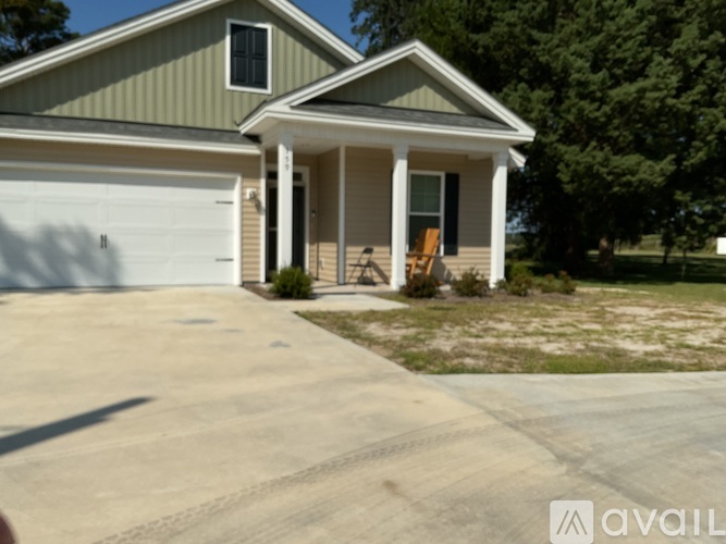 A house with a garage and a driveway in front.