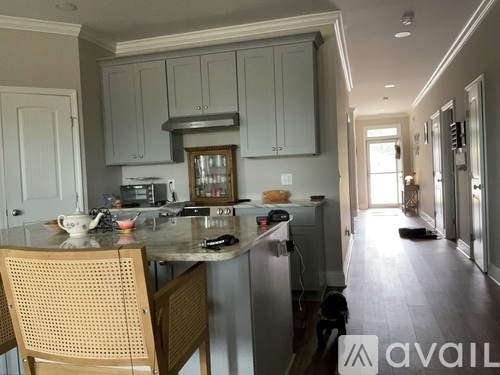 A kitchen with a table and chairs in front of a stove.