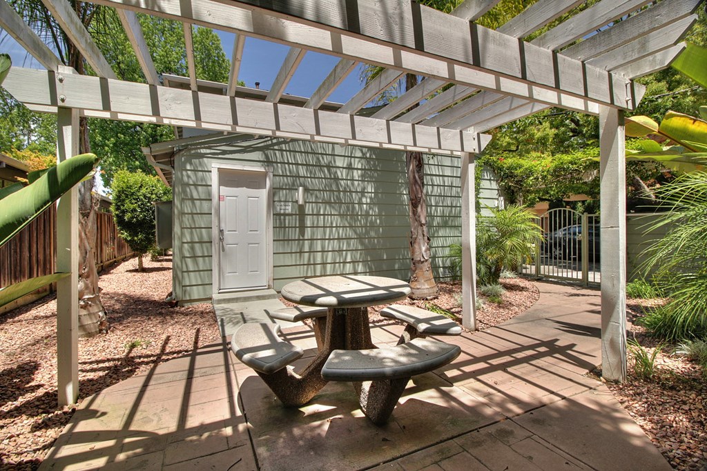 a patio with a picnic table and a door