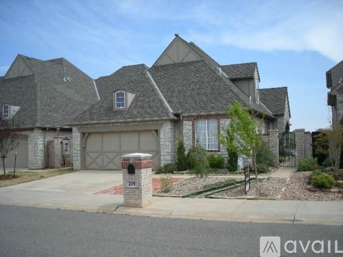 A house with a garage and a driveway in front.