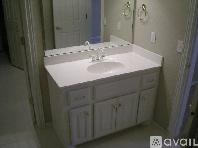 A bathroom vanity with a sink and mirror.