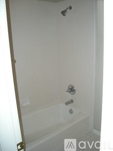 A white bathroom with a tub and shower.