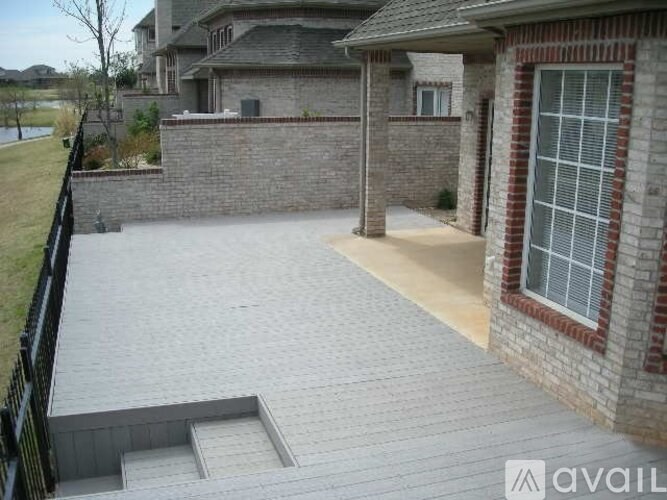 A house with a patio and a black fence.