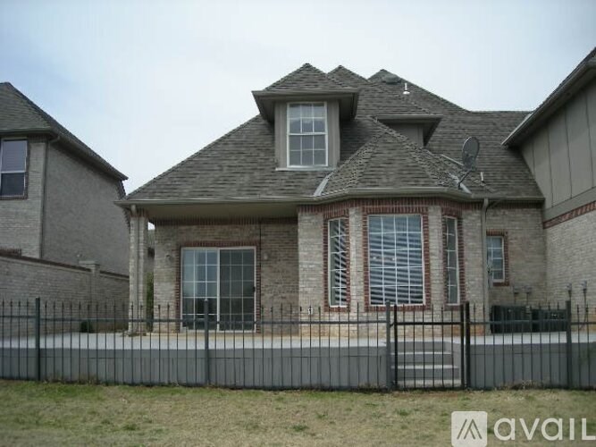A house with a black fence in front of it.