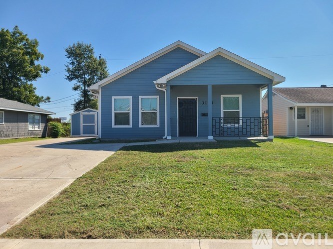 A small blue house with a black door and windows.