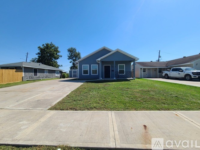 A blue house with a white car parked in front.