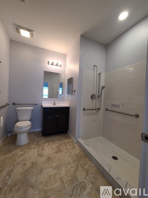 A bathroom with a toilet, sink, and shower.