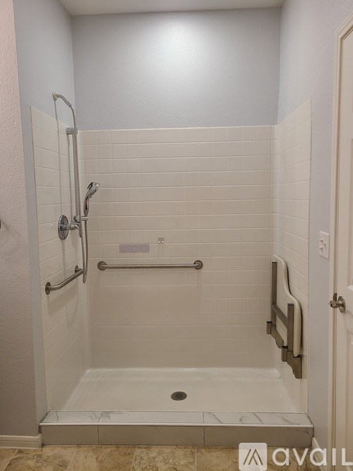 A bathroom with a walk in shower and a door.