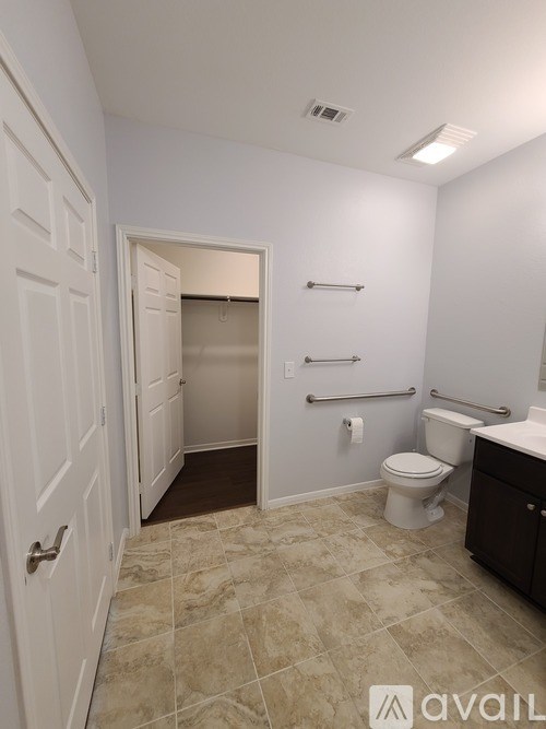A bathroom with a toilet, sink, and a walk-in shower.
