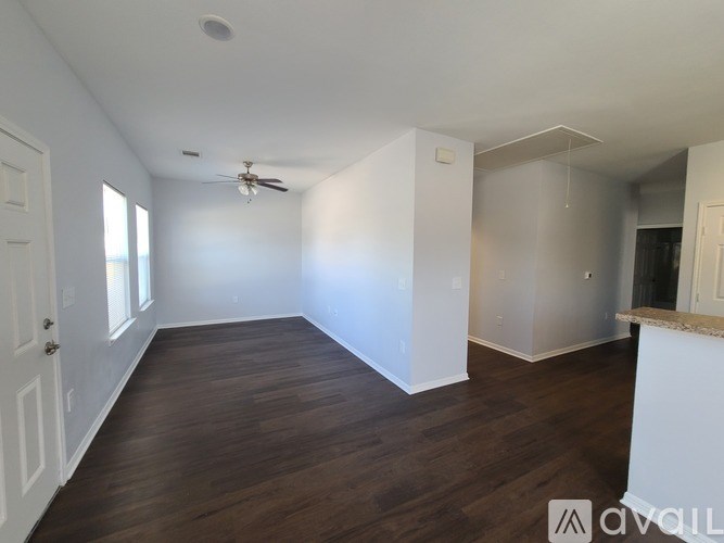 A room with wooden floors and white walls.