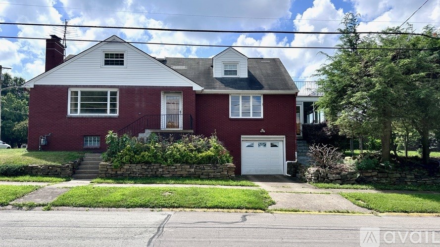 A red brick house with a white garage door.