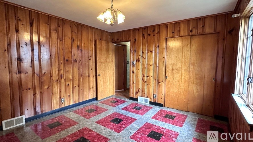 A room with wooden walls and a checkered floor.