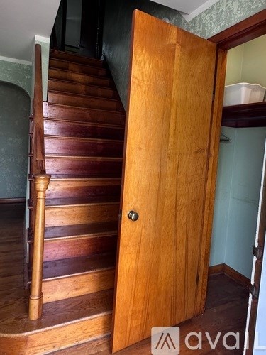 A wooden staircase with a door on the side.