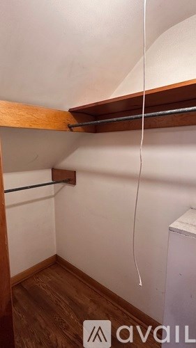 A small room with a shelf and a white appliance.