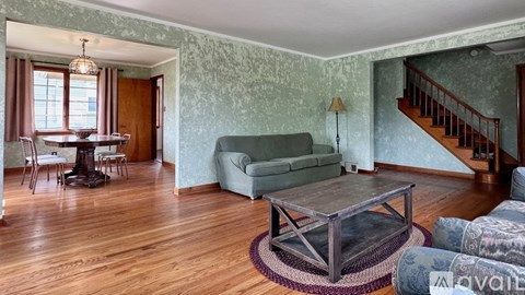 A living room with a green couch and a wooden coffee table.