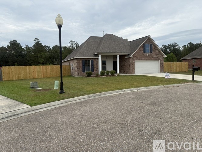 A house with a garage and a driveway in front.