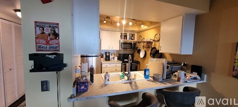 A kitchen area with a counter and a fridge.