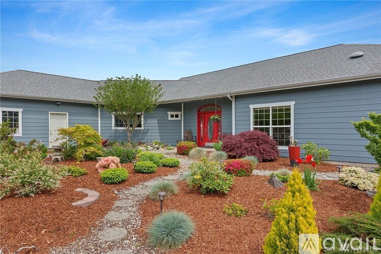 A house with a red door and a garden in front.