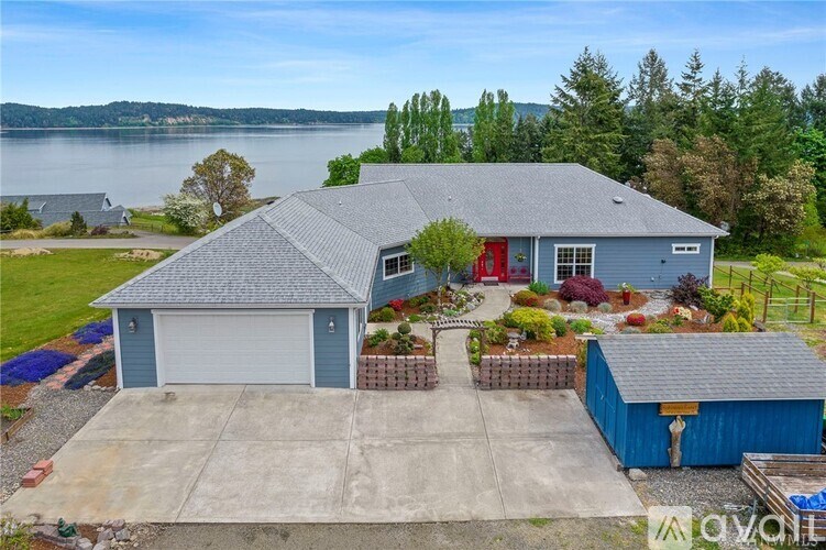 A house with a garage and a shed is for sale.