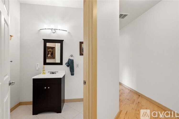 A bathroom with a sink and a mirror.