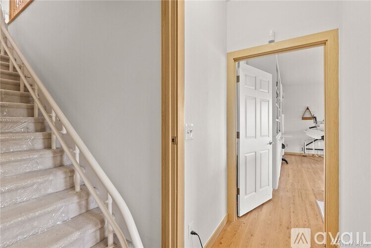 A wooden staircase with a mirror on the wall.