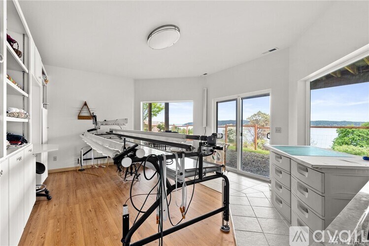 A room with a large desk and a chair with a laptop on it.