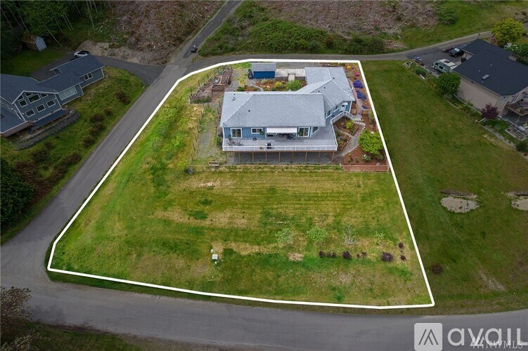 A property with a house and a large yard is for sale.