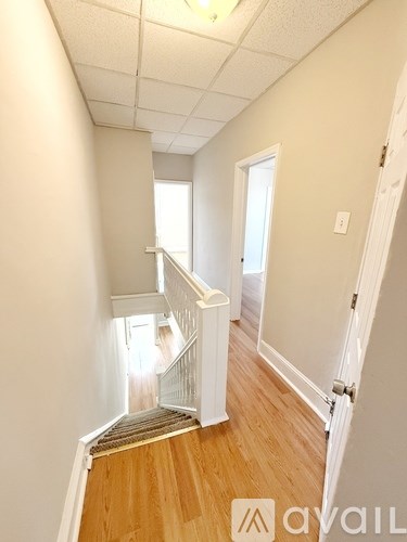 A hallway with a staircase leading to the second floor.