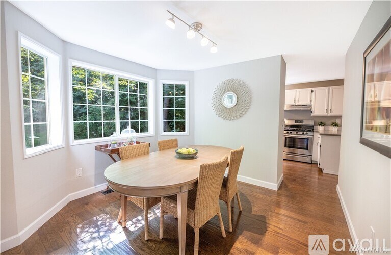 A dining room with a round table and chairs.