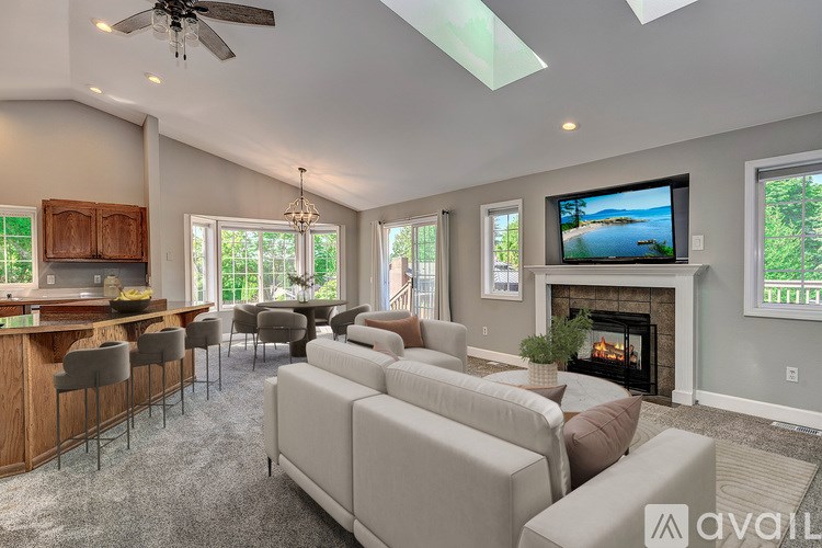 A modern living room with a fireplace and a television.