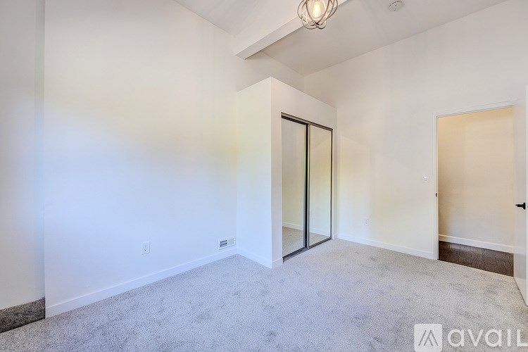 A room with a carpeted floor and a ceiling light.