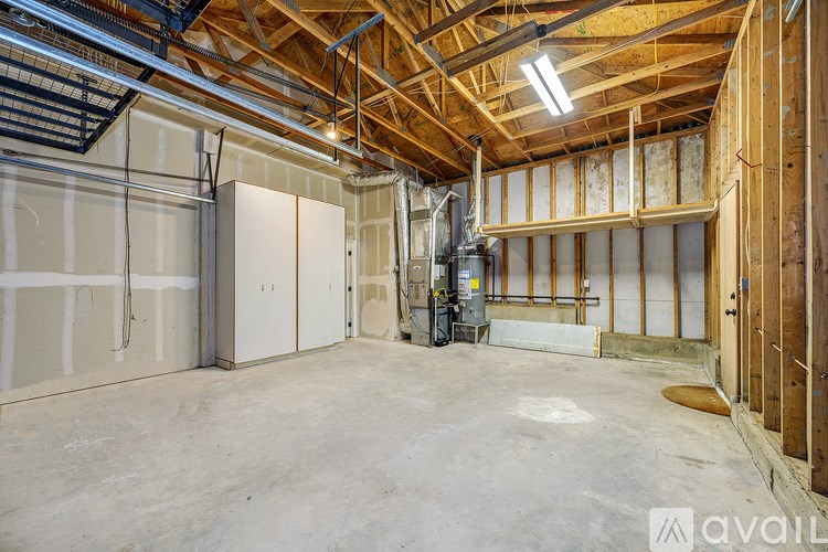 A large, empty room with a high ceiling and exposed wooden beams.