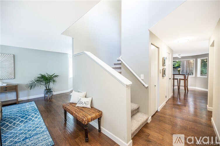 A staircase with a white railing and a wooden handrail.