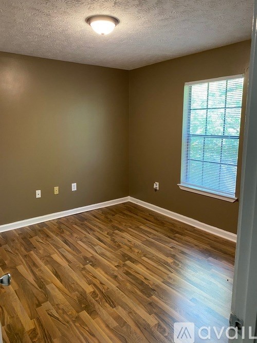 A room with brown walls and wooden flooring.