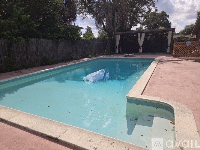A pool with a blue tinted water.