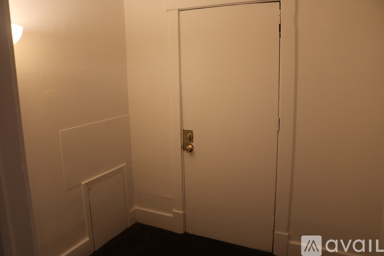 A white door with a silver handle in a room.