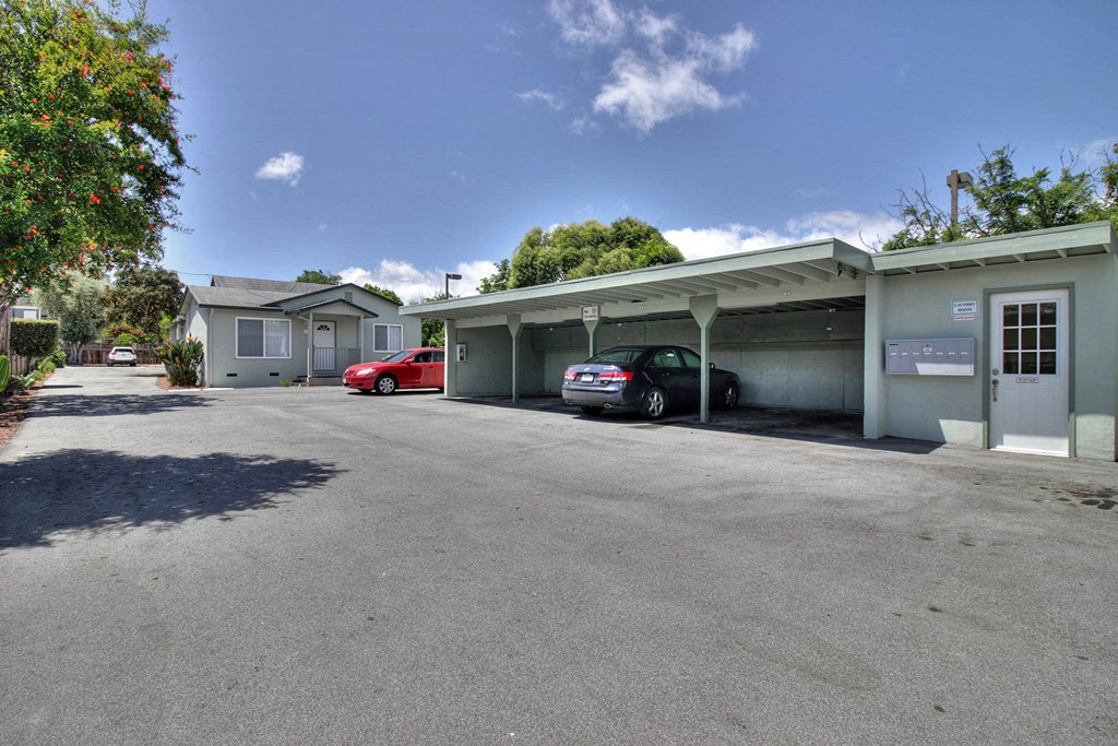 A parking garage with a car parked in front of it.