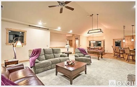 A living room with a grey sofa and a wooden coffee table.