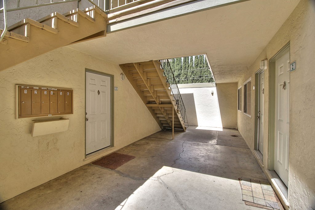 a hallway with a staircase and a door in a building