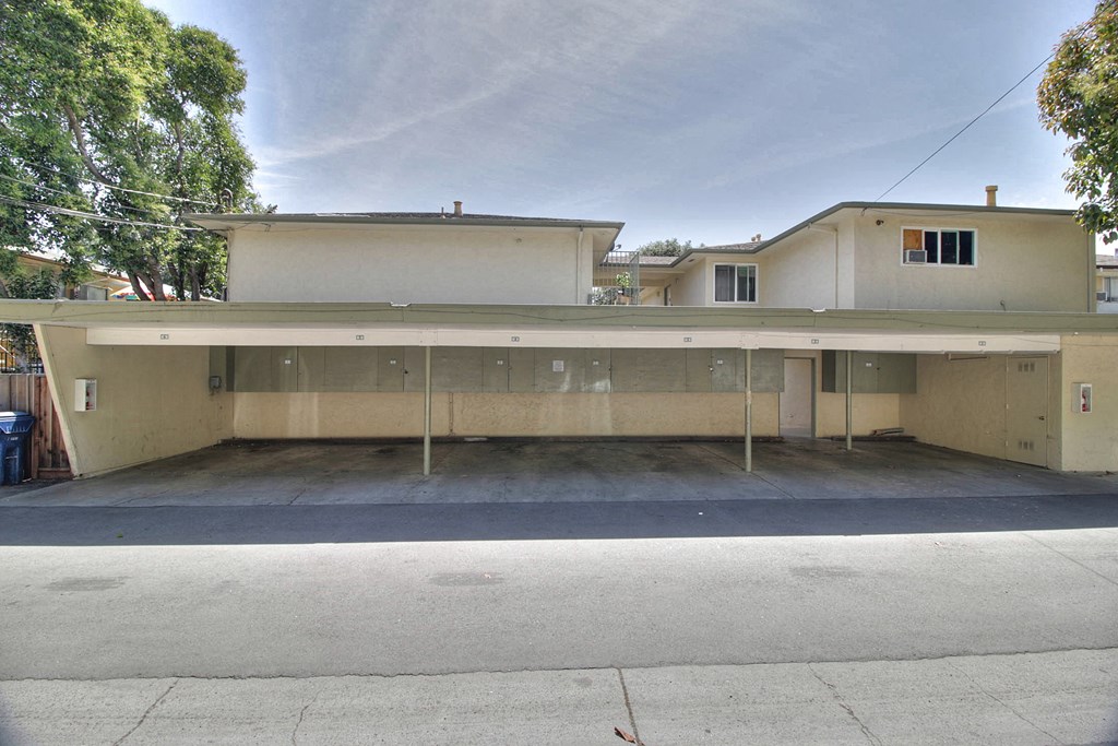 the front of a building with a parking lot